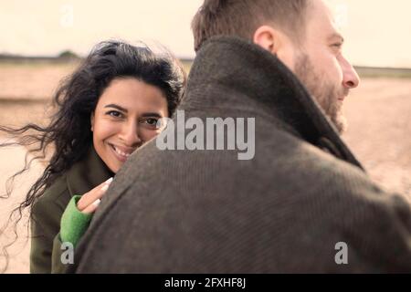 Portrait happy affectionate couple in winter coats Stock Photo