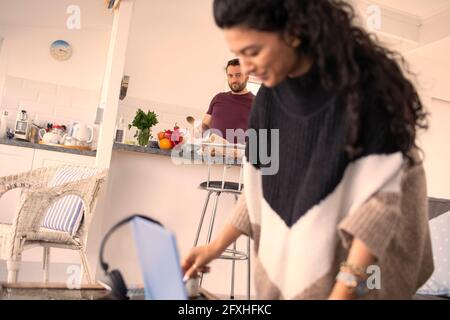 Couple working and cooking at home Stock Photo
