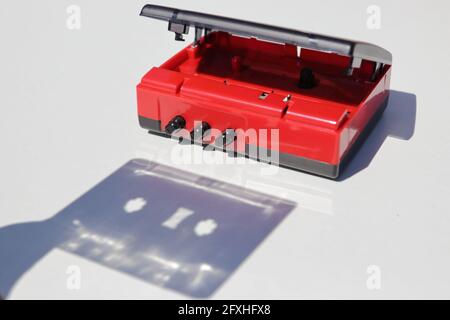 Shadow of cassette tape being inserted into a player Stock Photo