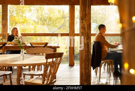 Business people working in sunny autumn cafe Stock Photo