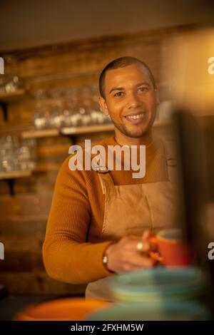 Portrait smiling confident male barista preparing coffee in cafe Stock Photo