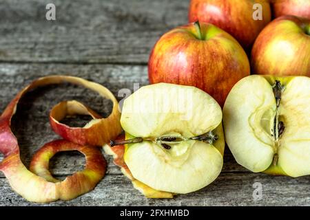 Whole apples and cut in half apples on wooden background Stock Photo