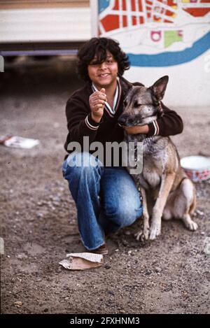A young Roma likes to be photographed with his dog Stock Photo