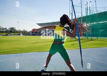 Female track and field athlete throwing javelin Stock Photo