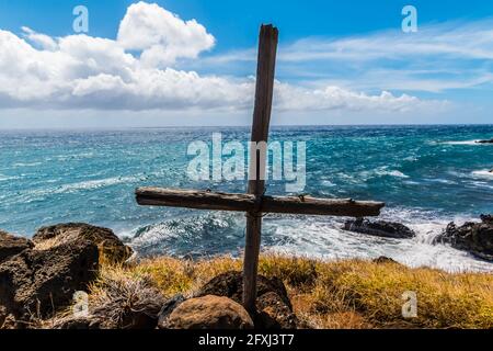 Handmade Cross on Hilltop Overlooking a Sea Arch Formed in The Lava Flows on The Palani Highway, Maui, Hawaii, USA Stock Photo