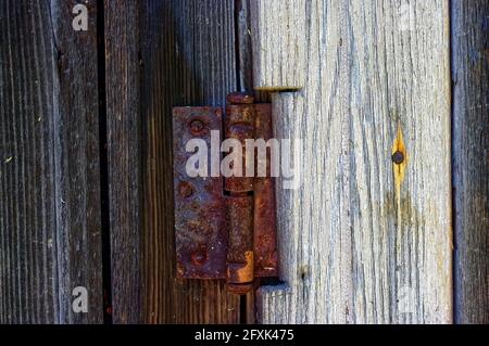 rusty door hinge on the barn, in the summer Stock Photo