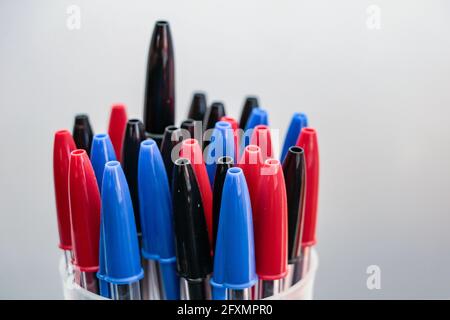Set with various pens in blue, black and red colors arranged in a circular shape Stock Photo