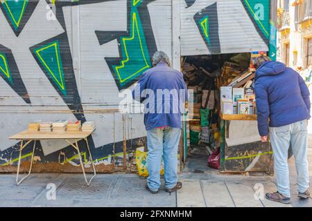 Valencia, Spain, April 17, 2021: Second hand book shop in old premises at old town, books on a table in the street Stock Photo