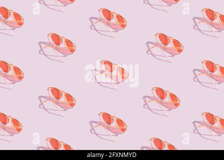 Orange sunglasses pattern on violet pastel background. Minimal summer concept. Isometric layout Stock Photo