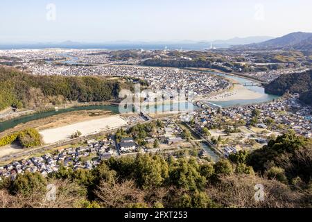 A top view of Kintaikyo bridge, Nishiki river and nearby old townscape from the observatory in Iwakuni Castle. Stock Photo