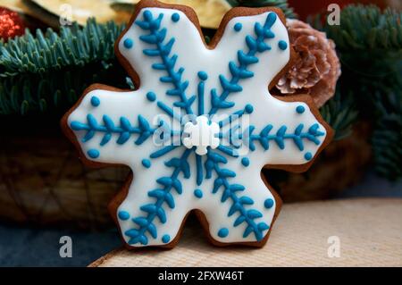 Christmas gingerbread in the form of snowfields. Christmas tree in the background Stock Photo