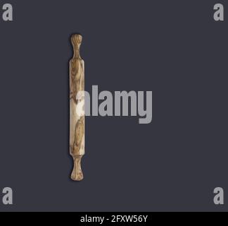 Top up view olive wooden rolling pin isolated on dark background. suitable for your design element. Stock Photo