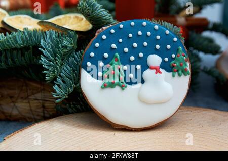 Christmas gingerbread with winter pattern. Christmas tree in the background. Stock Photo