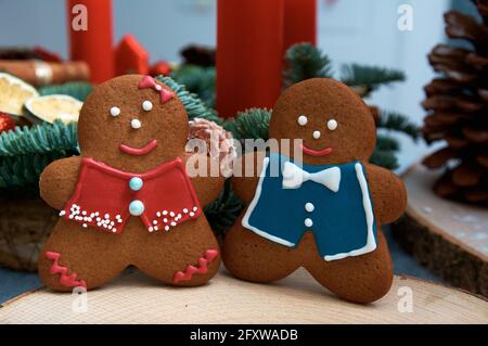 Christmas gingerbread in the shape of merry men. Christmas tree in the background. Stock Photo