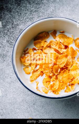 Close-up of Cornflakes Cereal in Bowl on Plain Background Stock Photo