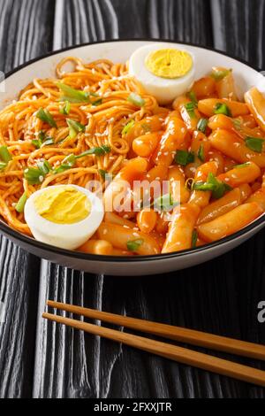 Rabokki is a type of tteokbokki with added ramyeon noodles it is a Korean street food closeup in the bowl on the table. Vertical Stock Photo