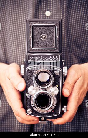 male photographer holding a Yashica 635 twin lens camera Stock Photo