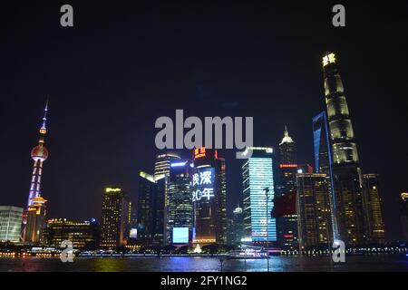 Skyscrapers of the Pudong area in Shanghai, China, illuminating in the evening for thousand of tourists who flock everyday to watch Stock Photo
