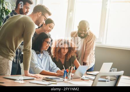 Friendly young people showing support to their office colleague Stock Photo