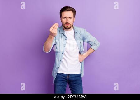 Photo of angry young mad unhappy man demand money hold hand italian isolated on violet color background Stock Photo