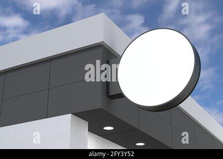 Closeup view of a blank circle shaped billboard with a white space attached to the wall Stock Photo