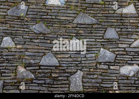 Stone wall at one of the Mushroom Houses, at 101 Grant Street, designed by architect Earl Young in the 20th Century, Charlevoix, Michigan, USA [No pro Stock Photo