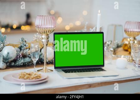 laptop with green screen - chromakey near New Year's decorations. christmas theme. Stock Photo