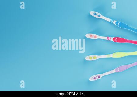 Four toothbrushes on a blue background. Free space, isolate Stock Photo