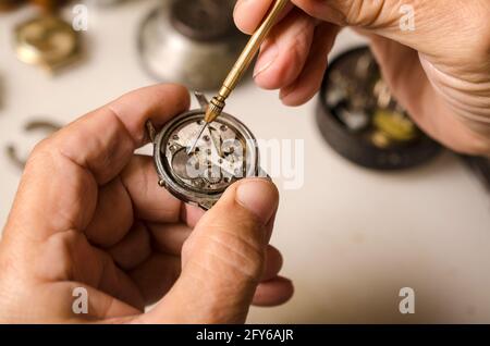 Repair of mechanical watches isolated on white Stock Photo