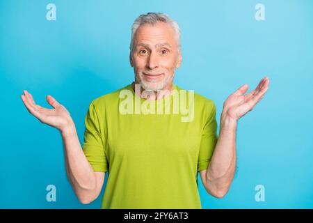 Portrait of attractive clueless grey-haired man shrugging shoulders isolated over vibrant blue color background Stock Photo