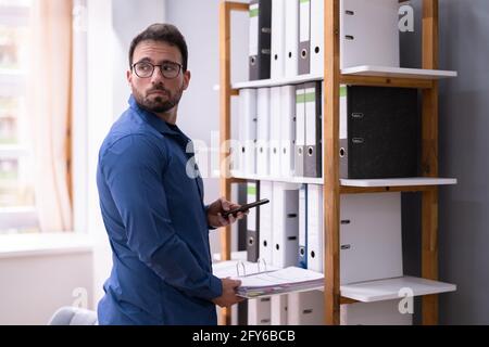 Stealing Trade Secret Document. Taking File Photo Stock Photo