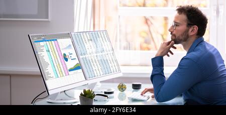 Analyst Employee Using Spreadsheet On Computer Screen Stock Photo