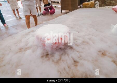 dry ice in a bowl on the floor. fog from dry ice on holiday. Stock Photo