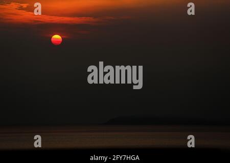 The sun sets over the horizon seen from Anilao in the province of Batangas, south of Manila, Philippines. Stock Photo