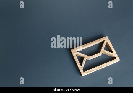 Wooden letter envelope. Contact concept. Postal correspondence. Mail notification. Communication internet technologies. Email. Business representation Stock Photo