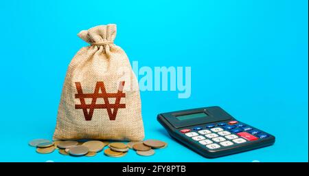 South korean won money bag and calculator. Accounting concept. Budgeting. Summing up the financial results. Analysis of loan selection. Calculation of Stock Photo