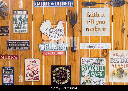 Johnson City, Texas, USA. April 10, 2021. Signs on the wall of a diner in the Texas hill country Stock Photo