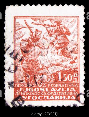 MOSCOW, RUSSIA - SEPTEMBER 23, 2019: Postage stamp printed in Yugoslavia shows Fighting Partisans, Partisan motifs serie, circa 1945 Stock Photo