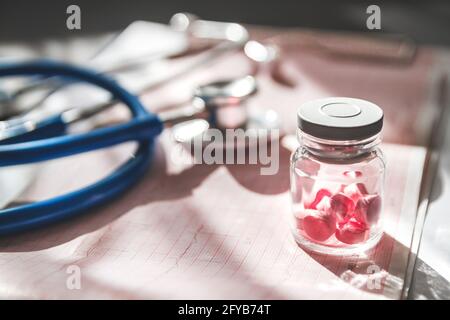 A patient's medical card close-up, a stethoscope and pills Stock Photo