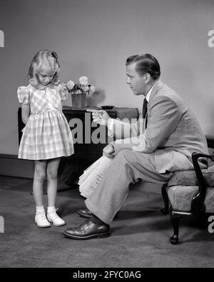 1940s LITTLE BLONDE GIRL HEAD DOWN BEING DISCIPLINED BY HER FATHER POINTING HIS FINGER WITH SERIOUS FACIAL EXPRESSION - j10518 HAR001 HARS EXPRESSION OLD TIME NOSTALGIA OLD FASHION 1 JUVENILE FACIAL ANGER FEAR COMMUNICATION WORRY LESSON LIFESTYLE PARENTING FEMALES STUDIO SHOT MOODY HOME LIFE COPY SPACE FULL-LENGTH DAUGHTERS PERSONS DISCIPLINE CARING MALES EXPRESSIONS TROUBLED FATHERS B&W CONCERNED SADNESS SUIT AND TIE PUNISHMENT HIS DADS DISCIPLINED MOOD CONCEPTUAL GLUM SUPPORT BEHAVIOR CONSEQUENCES COOPERATION JUVENILES MID-ADULT MID-ADULT MAN MISERABLE BLACK AND WHITE CAUCASIAN ETHNICITY Stock Photo