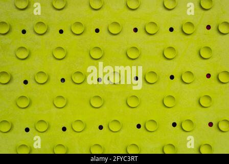 Rubber light green old cracked bath mat with holes and suction cups. Stock Photo