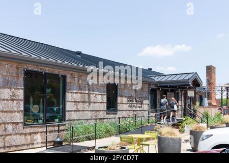 CHARLOTTE, NC, USA-23 MAY 2021: Camp North End's 'Good Postage' shop. Two people couple) entering. Stock Photo