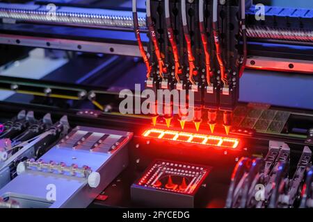 Automatic SMD pick and place machine assembling computer circuit board Stock Photo