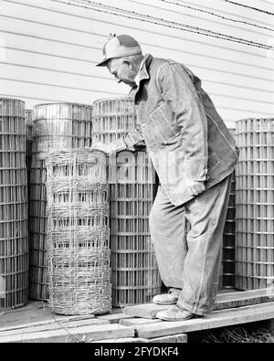 1930s 1940s 1950s MAN FARMER PURCHASING ROLL OF HOG WIRE FENCING FROM AGRICULTURAL SUPPLY STORE - s11352 BAU001 HARS FENCING COPY SPACE FULL-LENGTH PERSONS FARMING MALES PROFESSION CONFIDENCE MIDDLE-AGED AGRICULTURE B&W MIDDLE-AGED MAN SKILL OCCUPATION SKILLS PROTECTION HOG CAREERS CHOICE EXTERIOR FARMERS KNOWLEDGE LABOR AUTHORITY EMPLOYMENT OCCUPATIONS PORK HARDWARE SELECTION CONCEPTUAL AGRICULTURAL INSPECTING SUPPORT EMPLOYEE PURCHASING MID-ADULT MID-ADULT MAN SOLUTIONS SUPPLY BLACK AND WHITE CAUCASIAN ETHNICITY LABORING OLD FASHIONED SELECTING Stock Photo