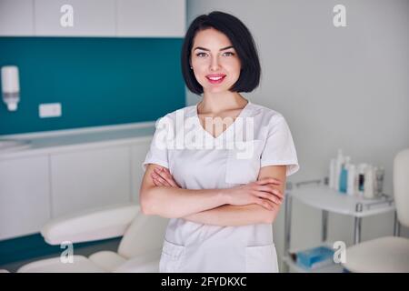 Happy attractive woman with cute smile posing at the camera in medicine center Stock Photo