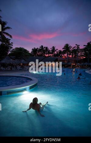 Colorful sunset over a pool in Costa Rica, Central America Stock Photo