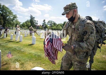 Arlington, United States. 27th May, 2021. Members of the 3rd US Infantry Regiment place flags at Arlington National Cemetery in Arlington, Virginia, on Thursday, May 27, 2021. Soldiers placed approximately 260,000 small American flags at headstones in advance of Memorial Day on Monday. Photo by Tasos Katopodis/UPI Credit: UPI/Alamy Live News Stock Photo