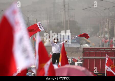 Lima, Peru. 26th May, 2021. People attend a campaign rally for Presidential candidate Pedro Castillo, in Villa El Salvador neighborhood. On June 6 Peruvians will go to the polls to elect new President between Castillo and Keiko Fujimori. Credit: Mariana Bazo/ZUMA Wire/Alamy Live News Stock Photo