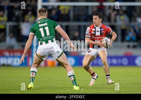 Eccles, UK. 27th May, 2021. Morgan Escare (1) of Salford Red Devils looks for a way past Ben Currie (11) of Warrington Wolves in Eccles, United Kingdom on 5/27/2021. (Photo by Simon Whitehead/SW Photo/News Images/Sipa USA) Credit: Sipa USA/Alamy Live News Stock Photo