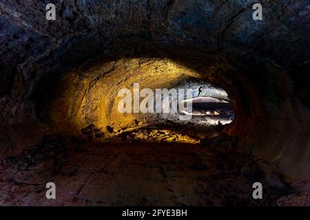 Dinh Quan District, Dong Nai Province, Vietnam - May 22, 2021: A female tourist explores a lava tunnel in Dinh Quan, Dong Nai province, Vietnam Stock Photo